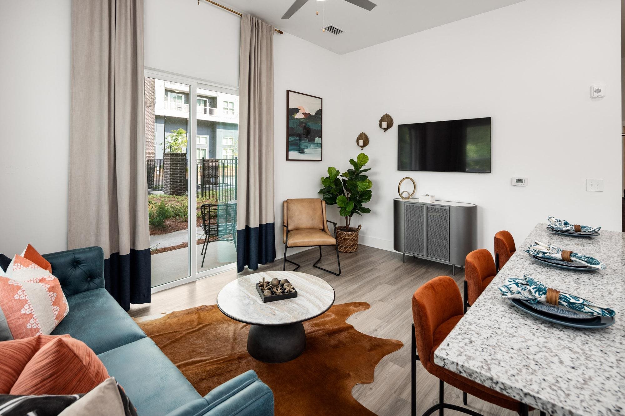 a living room with a couch and a table and a tv